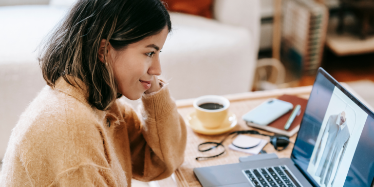 Person on computer with a coffee