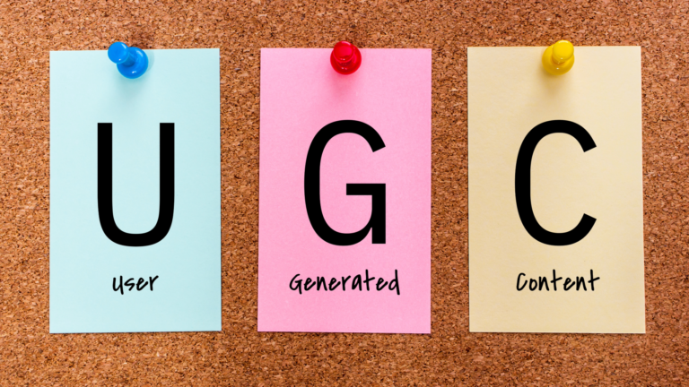 Post-it notes on cork board reading "UGC"