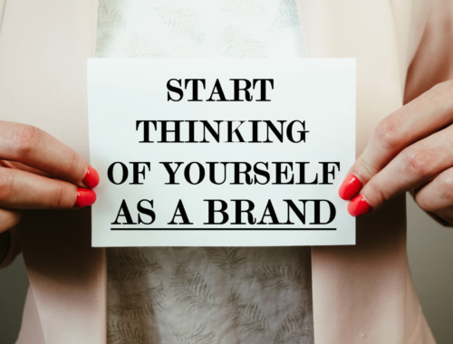 Person holding sign saying "start thinking of yourself as a brand"