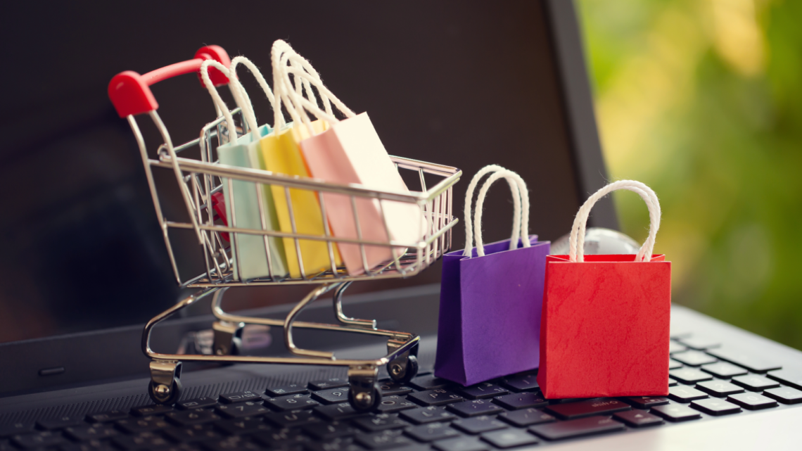 Mini shopping bags and trolley on a laptop