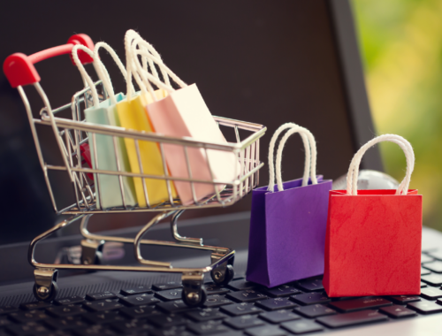 Mini shopping bags and trolley on a laptop