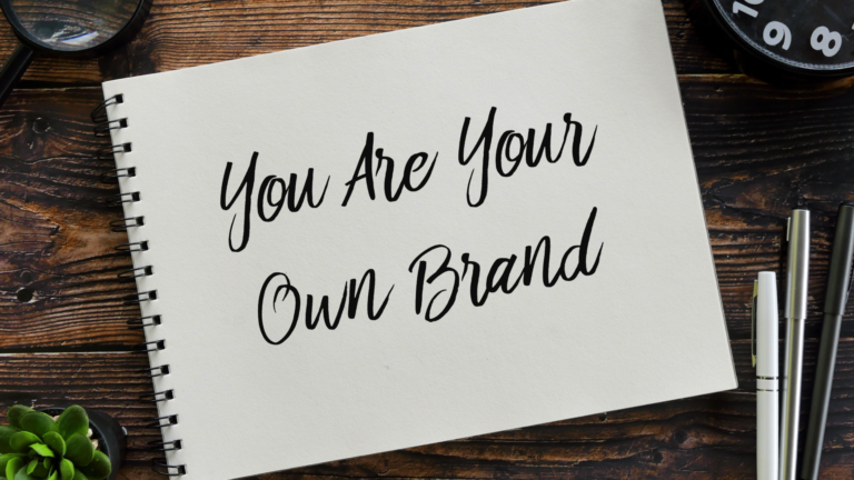 Writing on a sketchbook reading "you are your own brand"